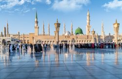 Musulmani di fronte alla moschea del profeta Maometto a Medina, Arabia Saudita. La tomba di Maometto si trova sotto la cupola verde - © hikrcn / Shutterstock.com