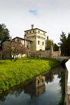Sesto al Reghena, provincia di Pordenone: il torrione d'ingresso all'Abbazia con il canale d'acqua e il ponte - © Diana Crestan / Shutterstock.com