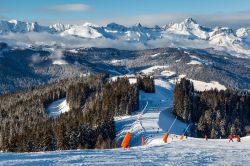 Veduta dall'alto di una pista da sci di Megève, Alta Savoia (Francia): sciatori si divertono sulla neve.
