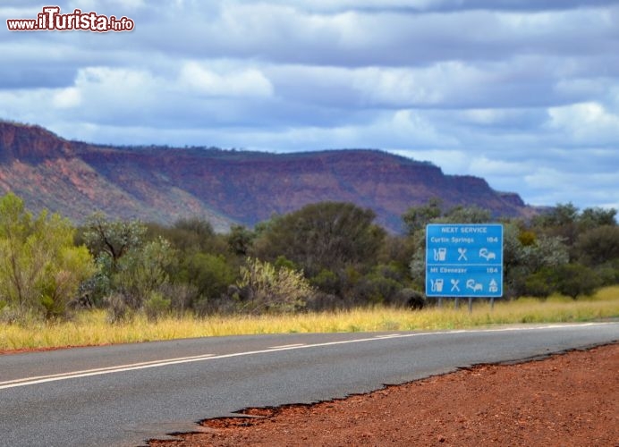 Immagine Strada per Kings Canyon, Northern Territory (Australia) - Come si può vedere dai cartelli stradali, nel Red Centre australiano si possono percorrere quasi 200 km prima di incontrare un distributore, ed è quindi buona regola riempire il serbatorio dell'auto a noleggio ogni qual volta si incontra una stazione di servizio