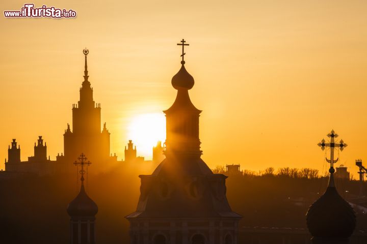 Immagine Alba in centro a Mosca, Russia - I colori caldi del sorgere del sole riscaldano l'atmosfera che si respira nel cuore della città russa: in questa immagine la sagoma dell'edificio che ospita l'Università moscovita  © Ranglen / Shutterstock.com