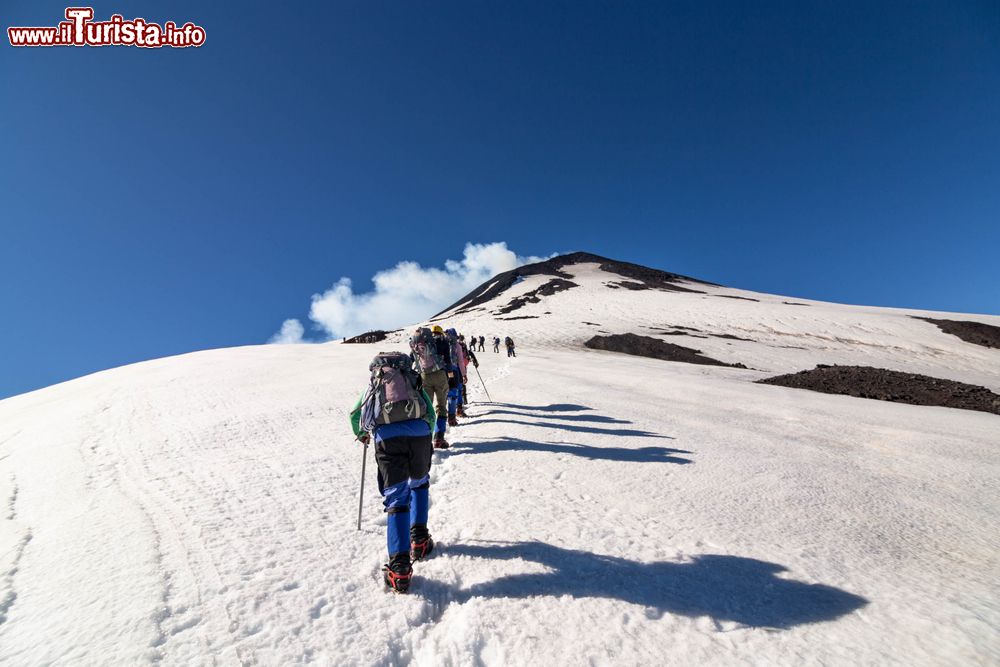 Immagine Escursionisti salgono sul vulcano Villarrica innevato, Pucon, Cile. La prima eruzione a memoria di uomo si è verificata nel 1558.