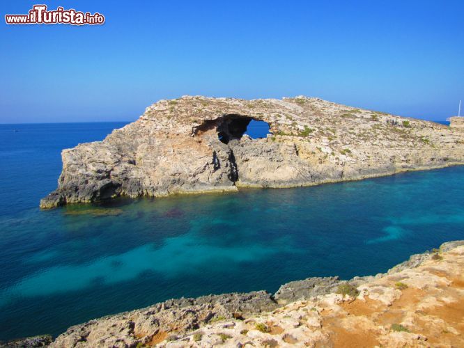 Immagine Formazioni rocciose a Comino, Malta - Un panorama mozzafiato? Guardatelo attraverso questa roccia brulla che si erge dal mare. Chiudete gli occhi e riapriteli: cosa vedete da questa finestra che si affaccia sul Mediterraneo? © esinel / Shutterstock.com