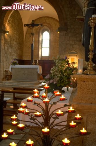 Immagine Interno della Chiesa di Santa Maria, Monteriggioni (Toscana) - Le capriate ben visibili, tipiche degli edifici religiosi nell'XI secolo, appartenevano anche alla Chiesa di Santa Maria, insieme a tre navate. In seguito il suo interno fu modificato. Nell'attualità abbiamo moltissimi elementi che richiamano alla tradizione neoclassica. Le due monofore poste ai lati opposti fanno filtrare una luce discreta e non invadente, in perfetta armonia con tutto il pathos delicato della struttura - © Robert Crum / Shutterstock.com