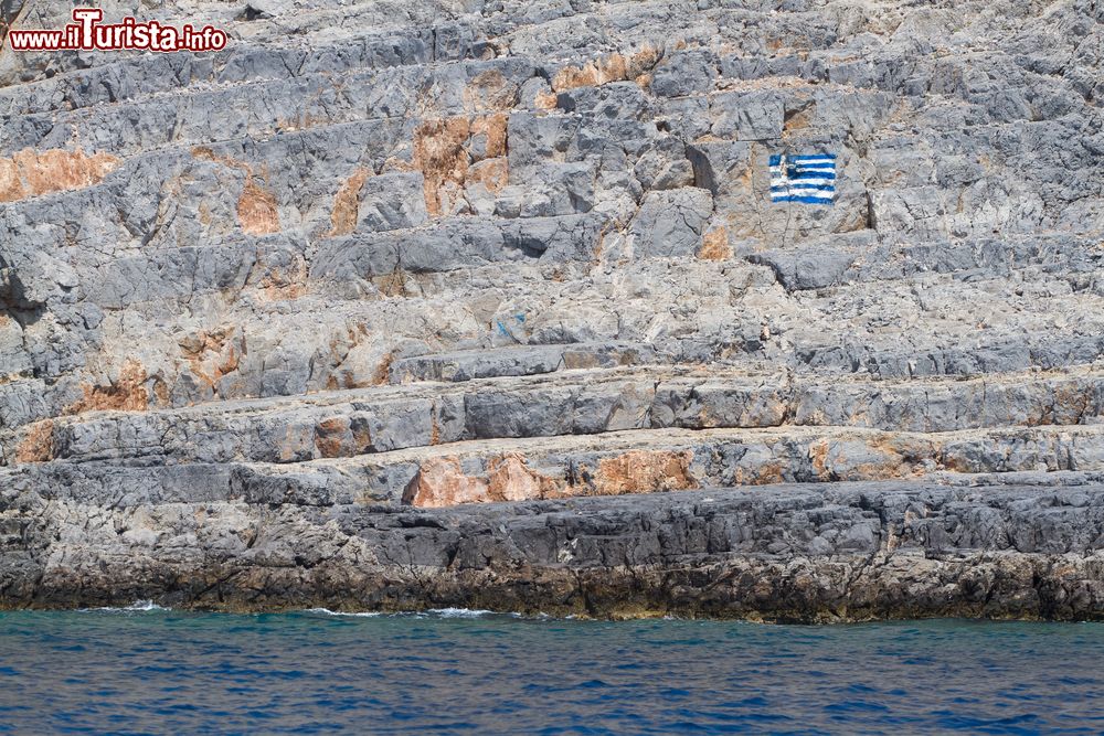 Immagine La bandiera greca disegnata su una scogliera dell'isola di Pserimos, arcipelago del Dodecaneso.