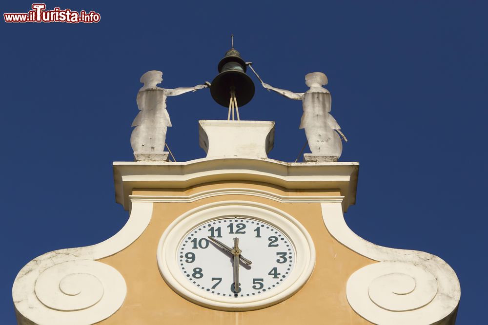 Immagine L'orologio in cima al Palazzo Municipale di Bardolino, Verona, Veneto. Sullo sommità vi sono la campana in ferro e due figure che rappresentano gli artigiani.