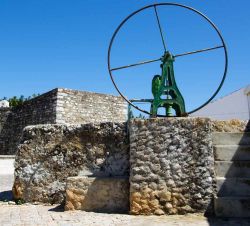 Antica pompa a mano per l'acqua a Cacela Velha, Portogallo - Dipinta di verde, nel cuore di questa cittadina costiera dell'Algarve si trova una tipica pompa a mano utilizzata per far ...