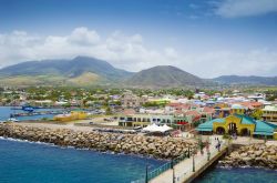 Porto Zante nella città di Basseterre, St. Kitts and Nevis, Indie Occidentali. Le belle montagne sullo sfondo fanno da scenario al porto e alle graziose case colorate.
