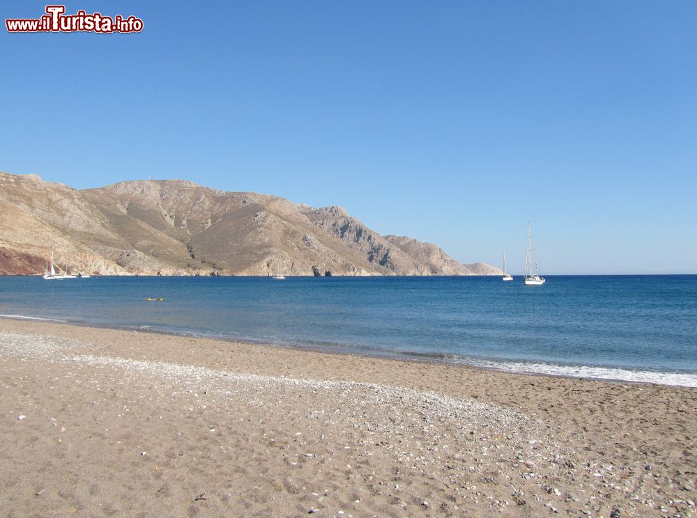 Immagine La spiaggia di Eristos a Tilos, Grecia. E' il tratto di spiaggia più lungo dell'isola con sabbia grigia grossolana mista a ciottoli e ornata da alberi.