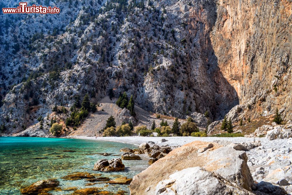 Immagine Una spiaggia di ghiaia sull'isola di Symi, Grecia. Arida, rocciosa e dura, quest'isola del Dodecaneso si trova 41 km a nord dalle coste di Rodi.