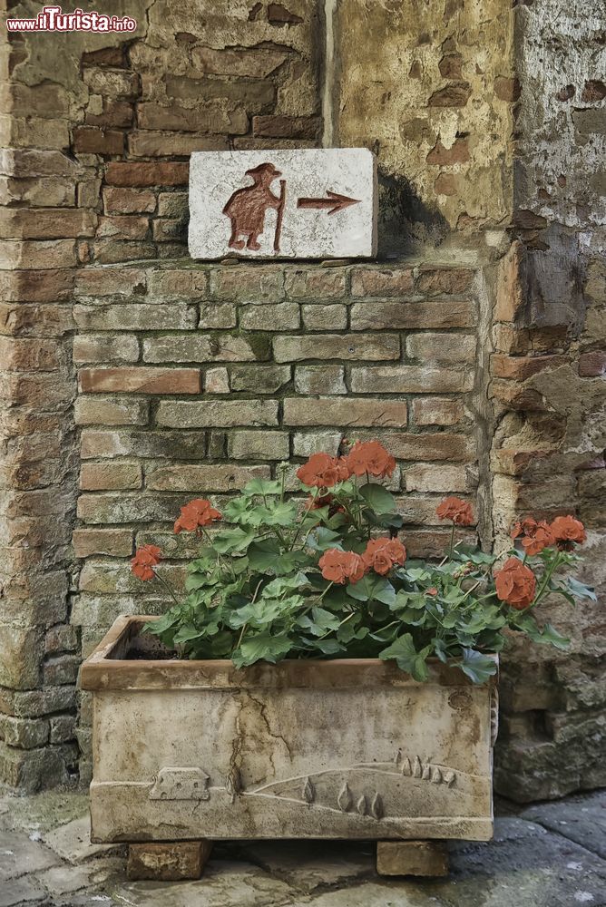 Immagine Un'insegna scolpita nella pietra in una via di Buonconvento, Toscana.