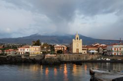 Acireale fotografata dal mare: sullo sfondo il vulcano Etna innevato, la cima più alta della Sicilia - © Oleg_Mit / Shutterstock.com