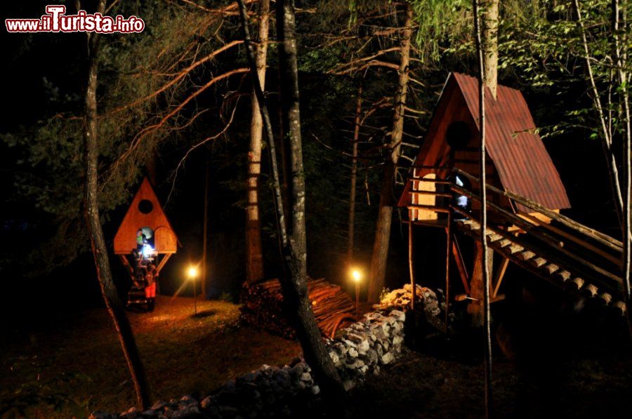 Immagine Vista nottruna del Tree Village di Claut in Friuli: è possibile pernottare dormendo nelle piccole casette di legno sosbese nel bosco- © www.montagna.es