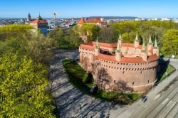 Il Planty park e la fortezza del Barbican nel centro di Cracovia in Polonia. Il parco è considerato il polmone verde della città, e venne creato lungo il percorso delle antiche ...